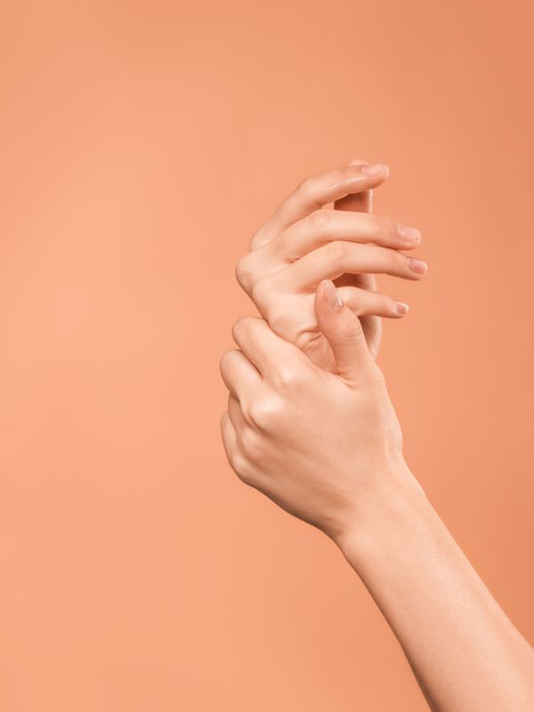 Step 4 Protect — elegant hands posed against a soft peachy-neutral background, clean and minimal skincare ritual