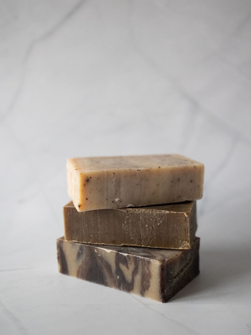 Forêt Cleansing Balm — stacked artisan botanical soap bars on white marble surface, clean minimal product photography