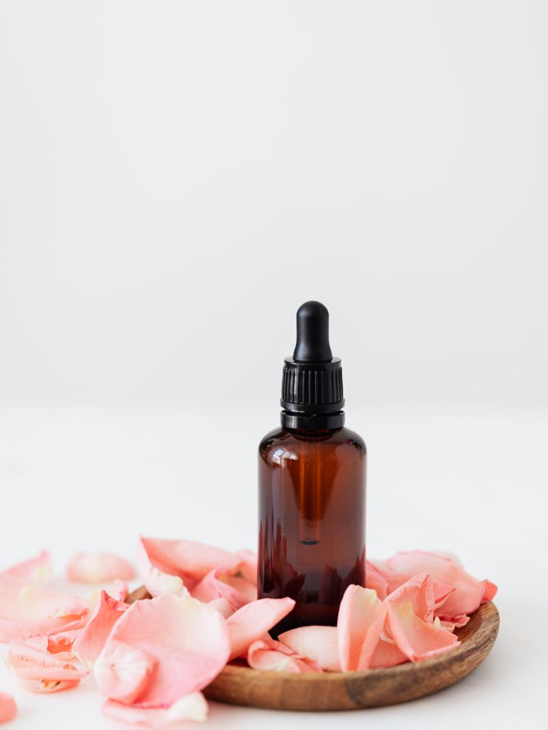 Lumière Eye Concentrate — amber glass dropper bottle with white botanical flowers on soft white background